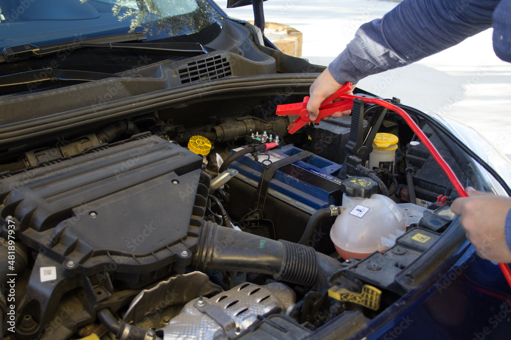 broken down car with low battery. Starting with cables broken down car with low battery. Starting with cables