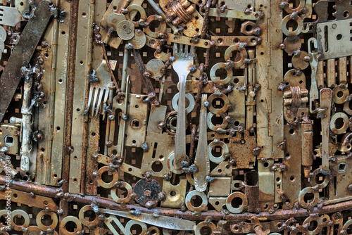 Grunge background, rusty metal details. gears, forks, fittings, wires and other old products are welded to uneven sheets of iron. Perfect for backgrounds and grunge designs. Steampunk grunge texture.