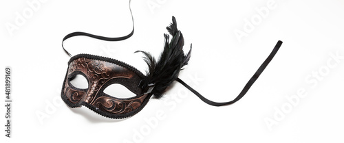 Carnival mask brown color with black feather decoration isolated on white background © Rawf8