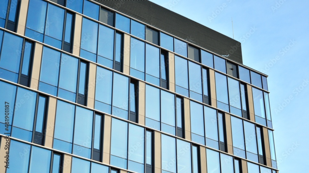 Modern glass corporate architecture with reflection of sky on the facade a sunny day Modern glass corporate architecture with reflection of sky on the facade a sunny day