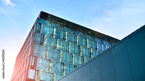 Modern glass corporate architecture with reflection of sky on the facade a sunny day