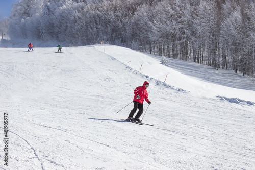 Man skiing downhill. Man in warm clothes posing while skiing. Winter season sports. Winter sports concept. Extreme sports skiing freestyle. Winter vacation on mountain.