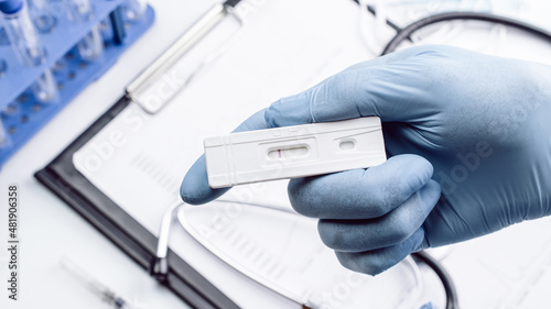 Covid test antigen coronavirus kit. Doctor holding rapid covid medical test. Laboratory hospital lab background. COVID-19 virus disease test, Coronavirus crisis.