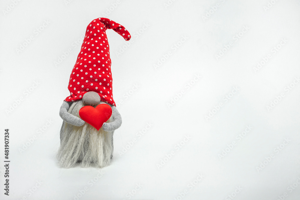 Dwarf in a red hat with a red heart in his hands isolated on a white background. Idea  valentine's day