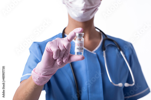 doctor holding vial. Vaccine. Mask face. Stay home. 
