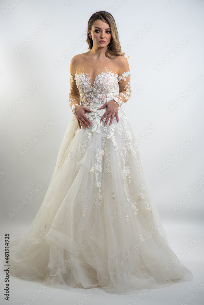 beautiful young blond woman in dress on white studio background beautiful young blond woman in dress on white studio background