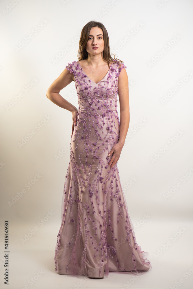 Full length tall slim luxurious elegant lush brown hair green eyes woman in evening neckline classic dress standing with manicure hands mannerly in side in front of on white studio background