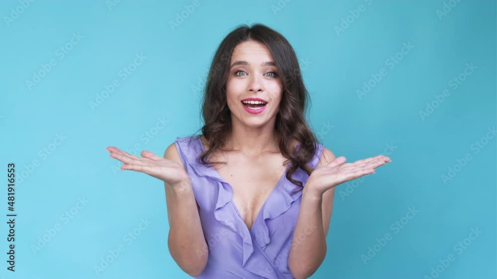 Invisible surprise. Happy woman. Meme expression. Pretty smiling lady clapping opening hands isolated blue looped video. Invisible surprise. Happy woman. Meme expression. Pretty smiling lady clapping opening hands isolated blue looped video.