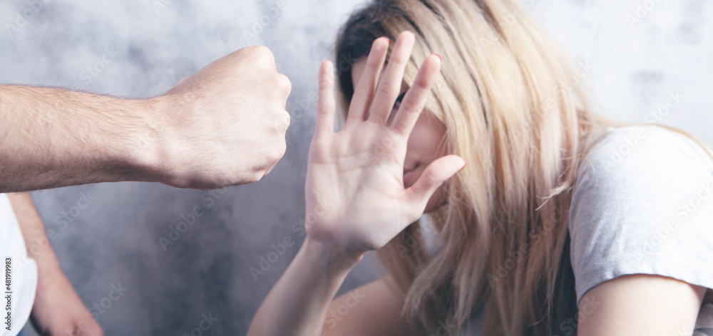 Fototapeta premium the husband wants to hit his wife. domestic violence
