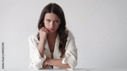 Angry woman. Stressed work. Meme expression. Sad gloomy lady closing and open laptop sitting sitting desk isolated white background looped video.