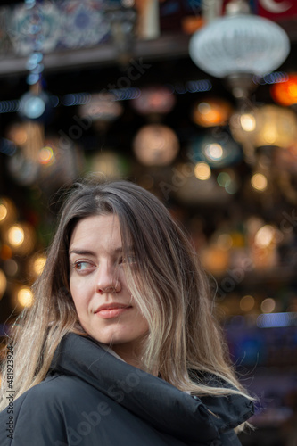 Wallpaper Mural Portrait of a beautiful girl looking back on the street with bright lights. Blurred background, bokeh lights. Copy paste web site banner. Vertical. Torontodigital.ca