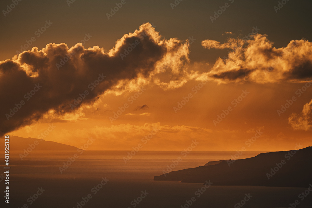 Wonderful colors sunset on the ocean with clouds and islands insilhouette in background. Concept of summer holiday vacation and timeless nature