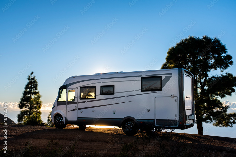 Big camper motorhome parked in off road nature space to enjoy total freedom. Off grid lifestyle vanlife. Travel with camping car and discover the beauty of the world