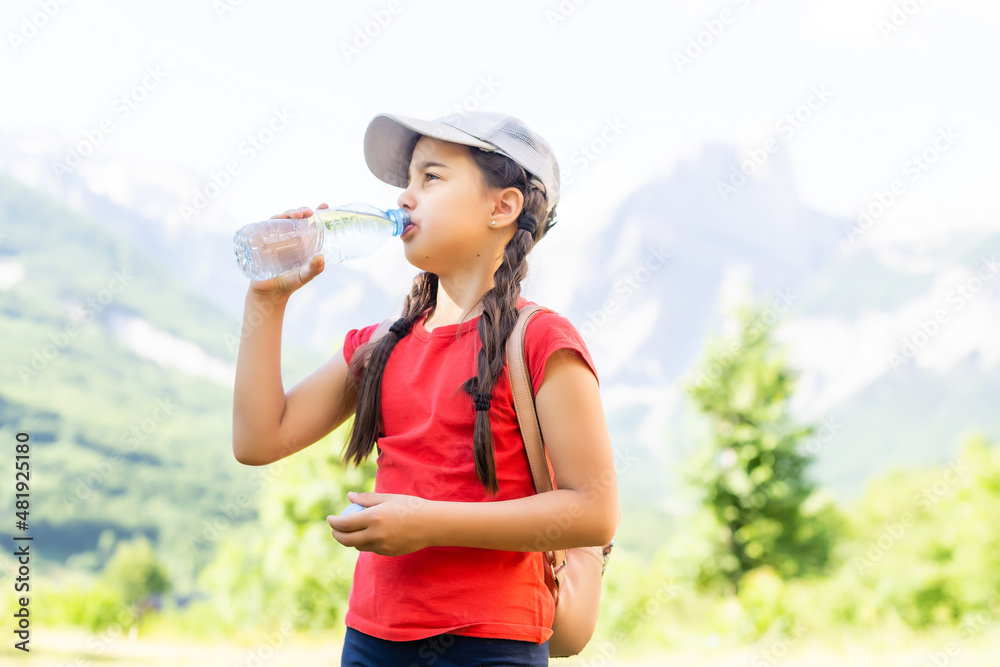 Portrait of a cute little girl in mountains.