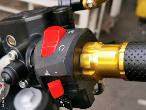 Close up image of motocycle start stop engine button.