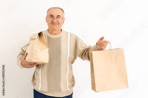 pensioner elderly retired man holding a packages.