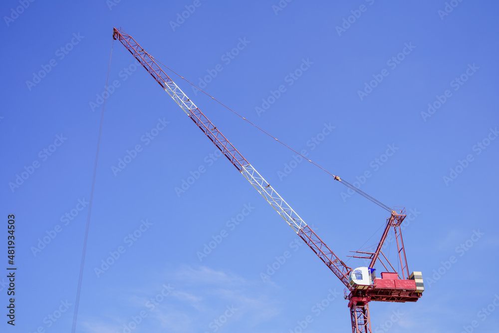 construction crane against bright sky background