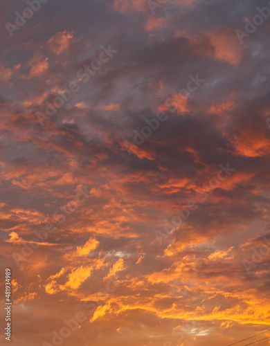 Dark orange red clouds with striking shades and a play of light. Vertical snapshot © Vitaly_MOKK