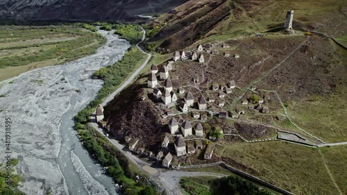 Aerial orbit North Ossetia unique Dargsvs city of dead. Many houses on top of rocky mountains, burial vault alpine crypt. Caucasus traditional historical culture village aul. photo