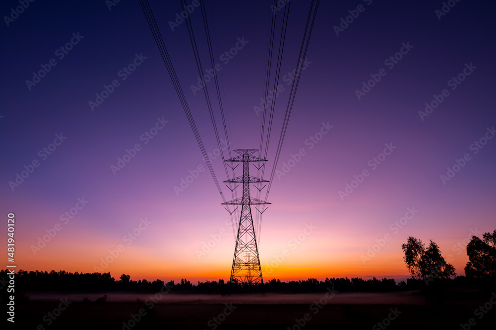 Silhouette street light post, electric pole and high voltage tower.High voltage transmission pole against morning sun background.