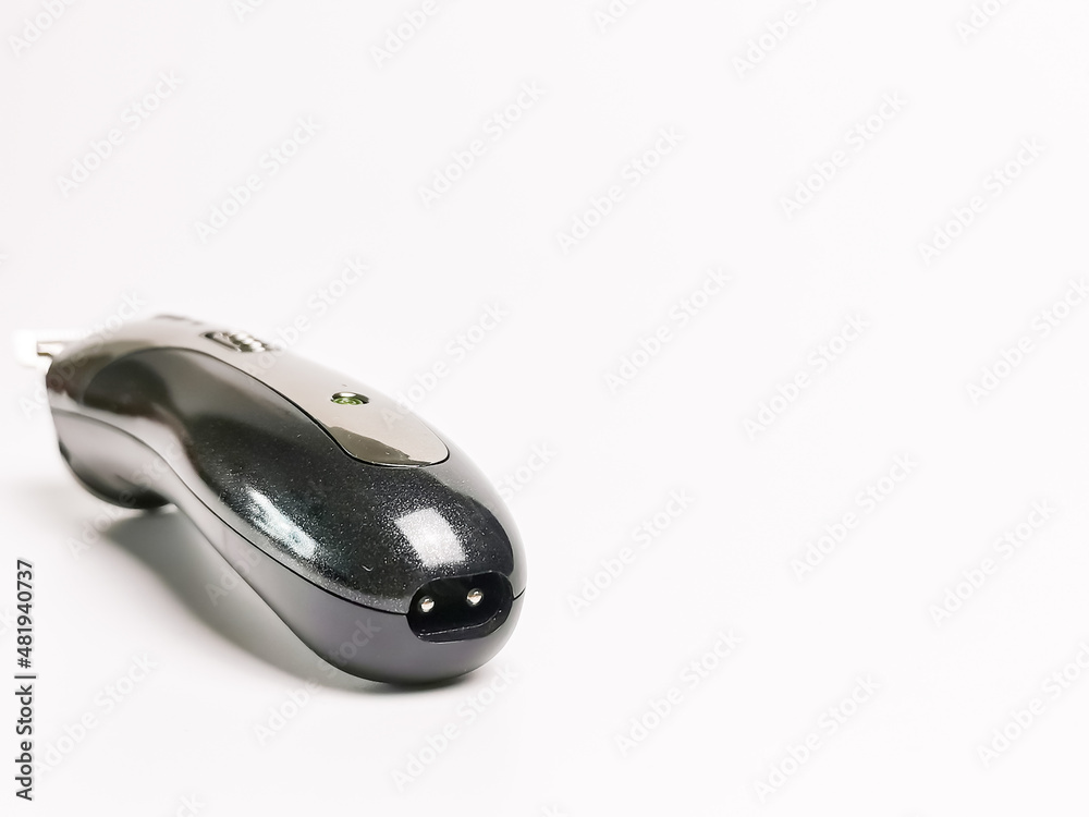 Rechargeable hair clipper charging port against white background. Rechargeable hair clipper charging port against white background.