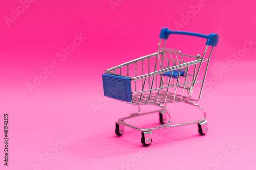 shopping cart isolated on pink background