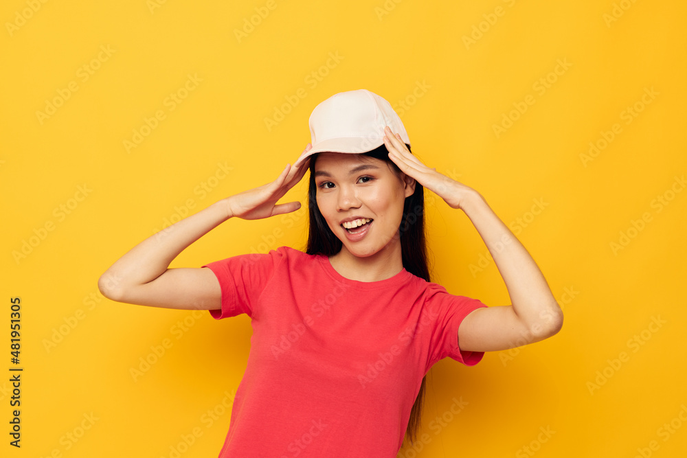 pretty brunette in a red t-shirt with a cap on her head pretty brunette in a red t-shirt with a cap on her head