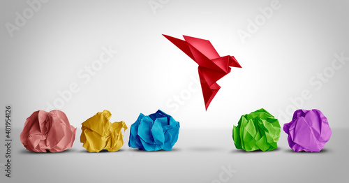 Concept of new idea and creative thinking as a symbol of innovation and inspiration metaphor as a group of crumpled papers with one different paper transforming into an origami bird in flight. 