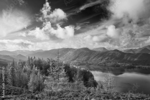 Black and white Beautiful landscape Autumn image of view from Walla Crag in Lake District, over Derwentwater looking towards Catbells and distant mountains with stunning Fall colors and light