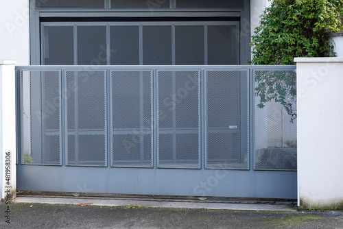 grey gate perforated sheet home aluminum portal of suburb house in street view © OceanProd
