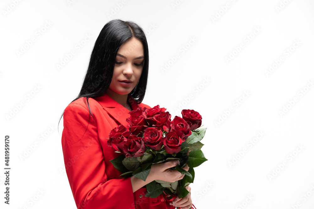Beautiful brunette holding a bouquet of red roses Beautiful brunette holding a bouquet of red roses