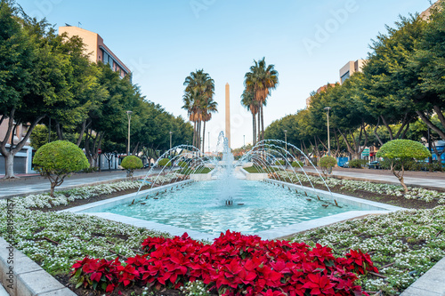 Water fountain and flowers next to the palm trees in the Belen street of the Rambla de Almeria, Andalucia. Spain. Costa del sol in the mediterranean sea photo