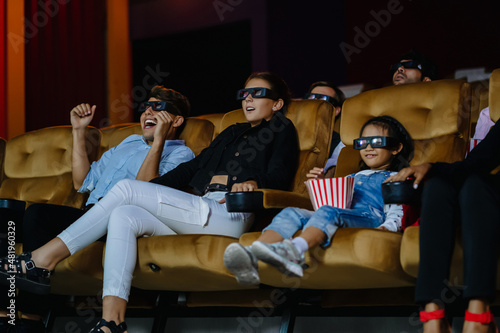Group of cheerful diversity people watching 3d movie in theater and laughing. Entertainment and people happy , action, horror and drama concept