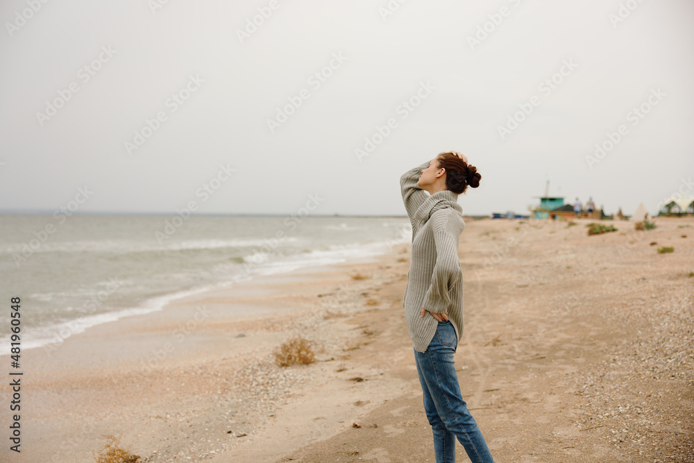 portrait of a woman cloudy weather by the sea travel fresh air Happy female relaxing portrait of a woman cloudy weather by the sea travel fresh air Happy female relaxing