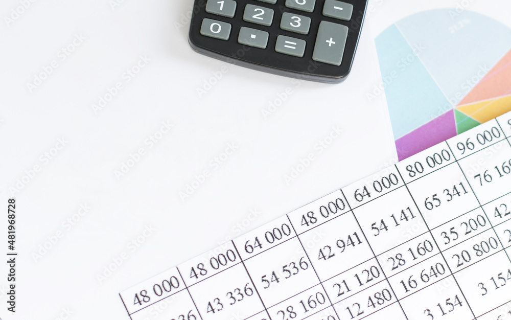 Business and financial concept. Calculator, report sheet, and blank notepad for text Business and financial concept. Calculator, report sheet, and blank notepad for text