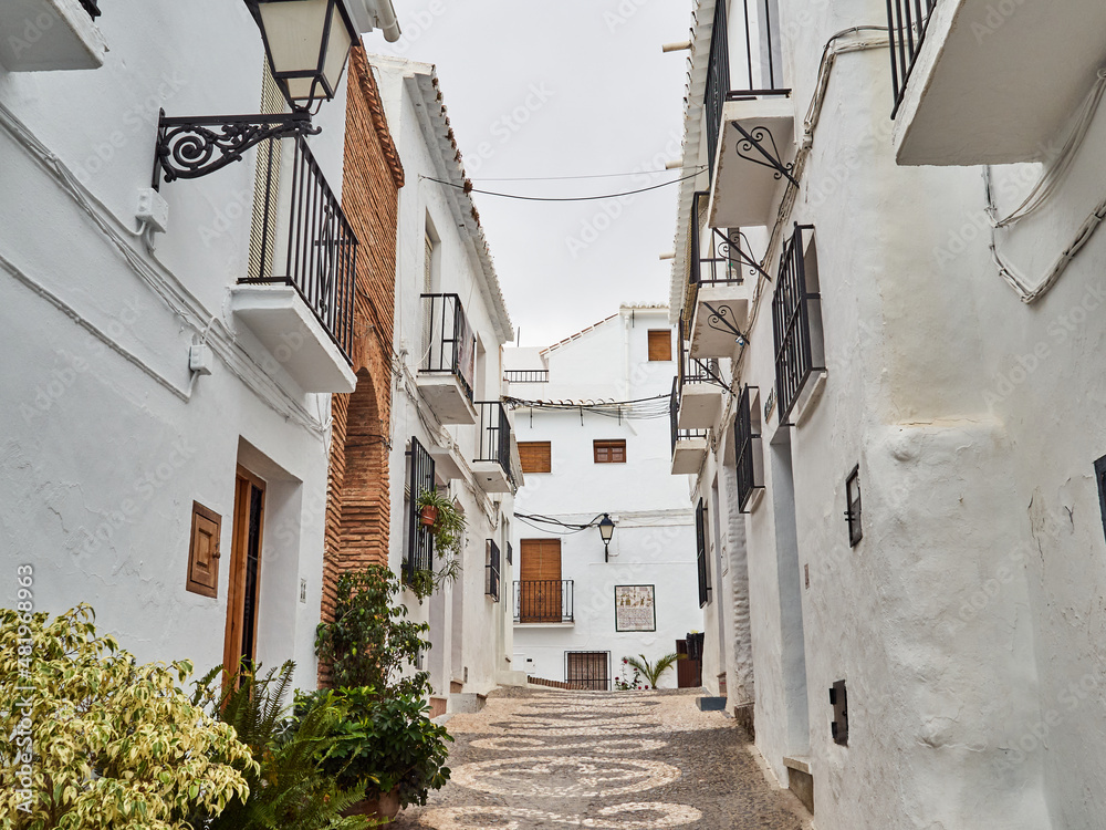 Typical street of Frigiliana, a small white village with cobblestone streets in the  Axarquía region of the Costa del Sol, Málaga province, Andalusia, Spain. Europe