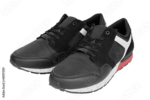 Stylish black sneaker made from a combination of faux leather and textile material and rubber sole isolated with white background. Casual shoes.