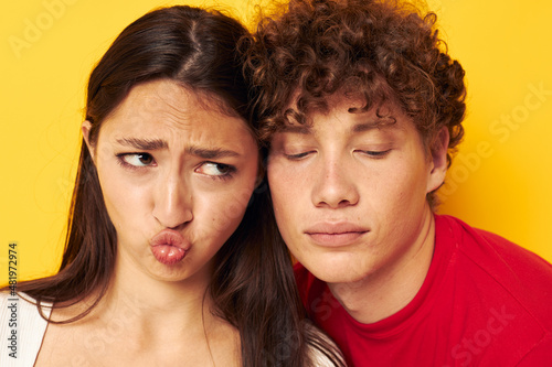 teenagers Friendship posing hugs together yellow background unaltered