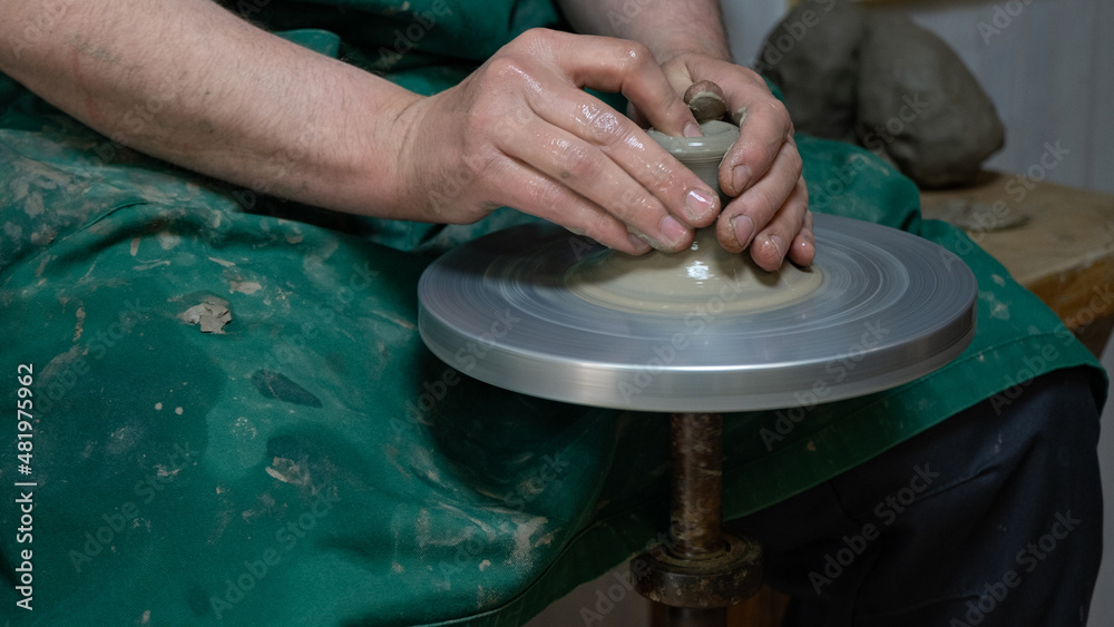 Potter at work. Hands of potter do a clay pot Potter at work. Hands of potter do a clay pot