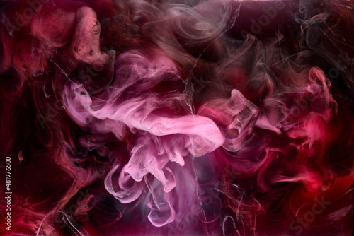 Pink smoke on black ink background  colorful fog  abstract swirling touch ocean sea  acrylic paint pigment underwater