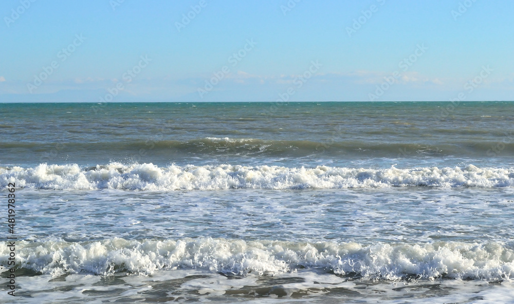 Seascape during a small storm and wind.Background, abstraction.Sea waves roll over one another, forming white foam. Seascape during a small storm and wind.Background, abstraction.Sea waves roll over one another, forming white foam.