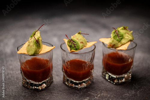 glasses of tomato drink garnished with crispy nachos with delicious sauce