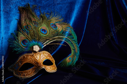 Luxury venetian mask on dark blue background. Carnival masquerade fantasy mask photo