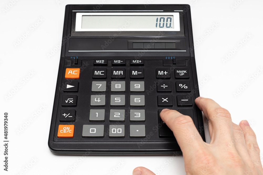the finger of the hand presses the keys of the old calculator the finger of the hand presses the keys of the old calculator