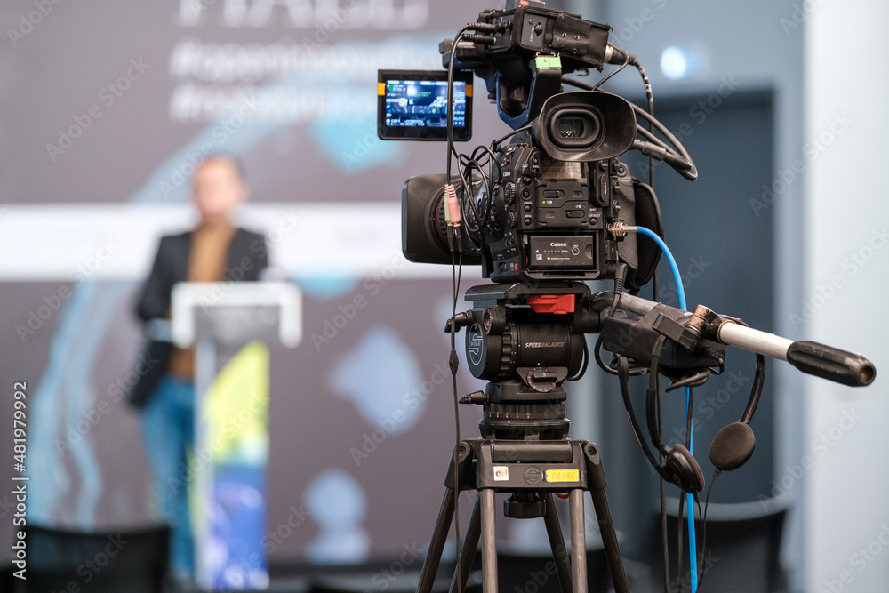 Camera recording speaker at business conference Camera recording speaker at business conference