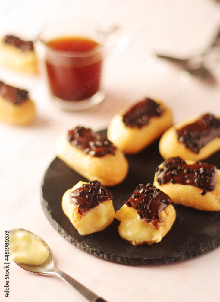 Traditional French dessert - eclairs with a cup of coffee Traditional French dessert - eclairs with a cup of coffee