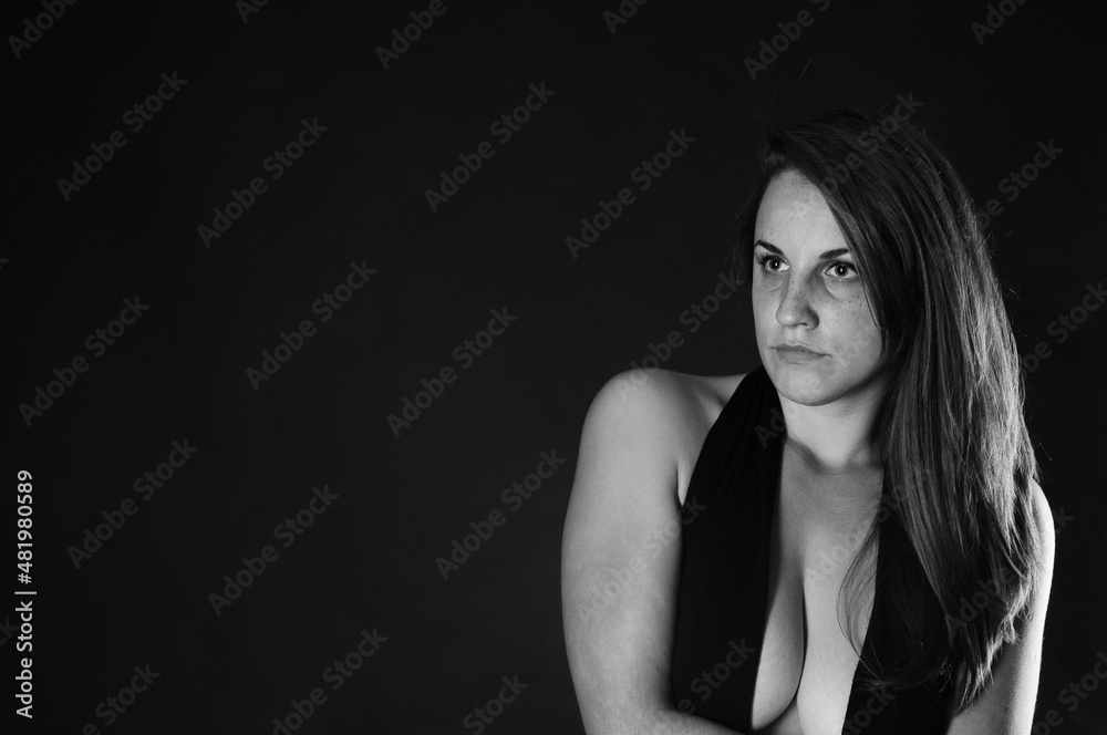 beautiful young brunette girl in a black blouse with a deep neckline close-up portrait on a black background
beautiful young brunette girl in a black blouse with a deep neckline close-up portrait on a black background