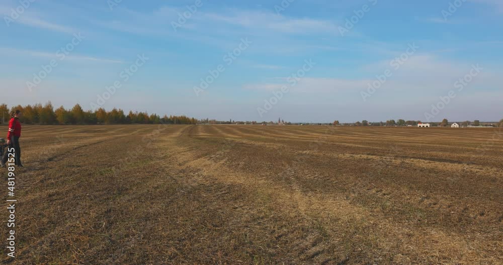 Child and Mother Hiking by Field in Slow motion. Happy Family having Walking in rural areas. Active Lifestyle. Child and Mother Hiking by Field in Slow motion. Happy Family having Walking in rural areas. Active Lifestyle.