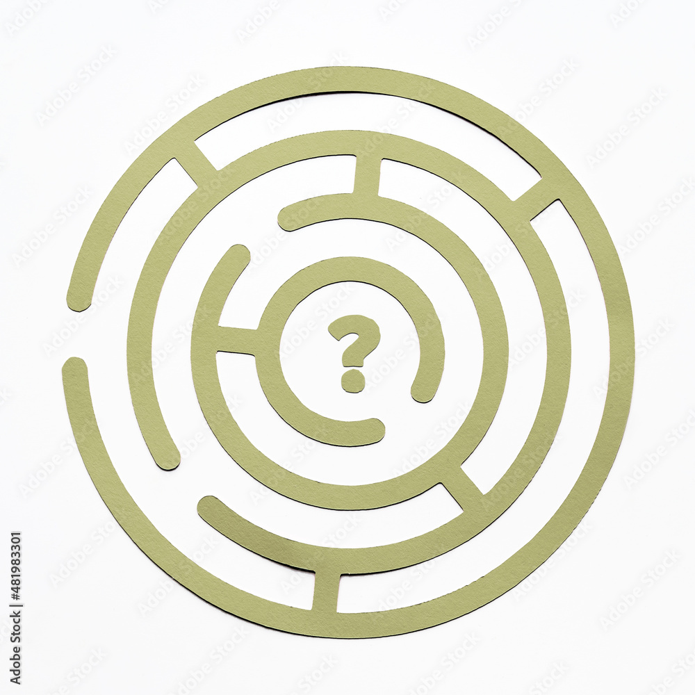 Round labyrinth maze game, find your path. Question mark in the center. Paper cut green element on off white background. Flat lay, top view. Round labyrinth maze game, find your path. Question mark in the center. Paper cut green element on off white background. Flat lay, top view.