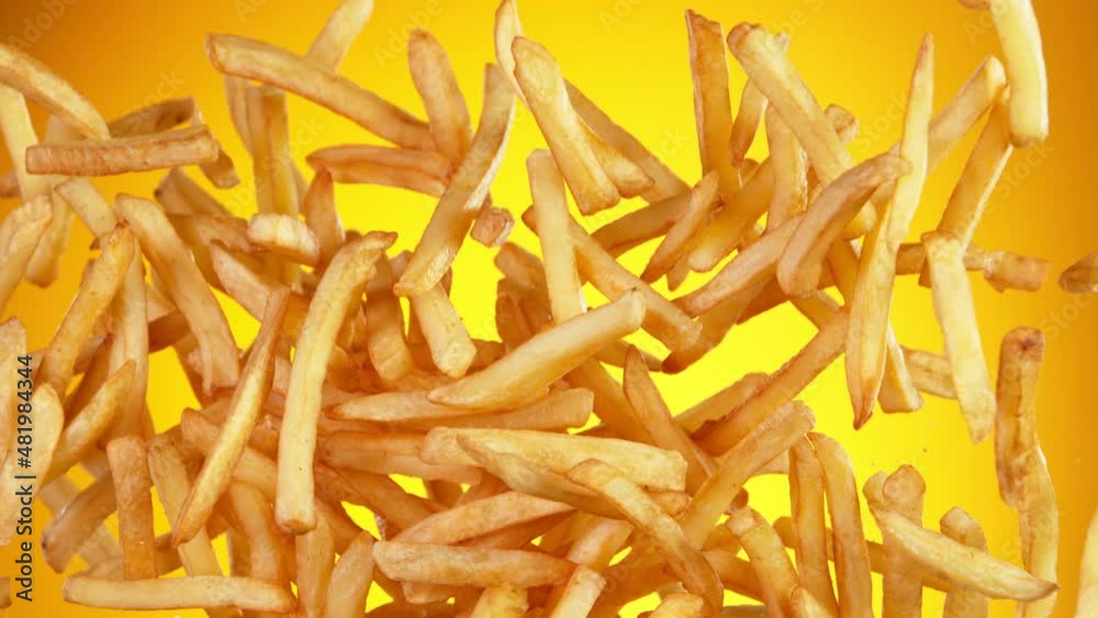 Super slow motion of flying french fries on golden background. Filmed on high speed cinema camera, 1000fps. Super slow motion of flying french fries on golden background. Filmed on high speed cinema camera, 1000fps.